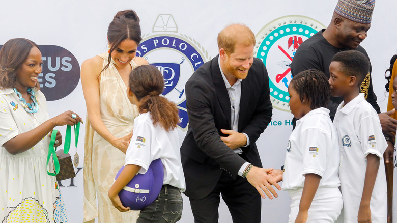 Meghan Markle and Prince Harry meeting children in Nigeria