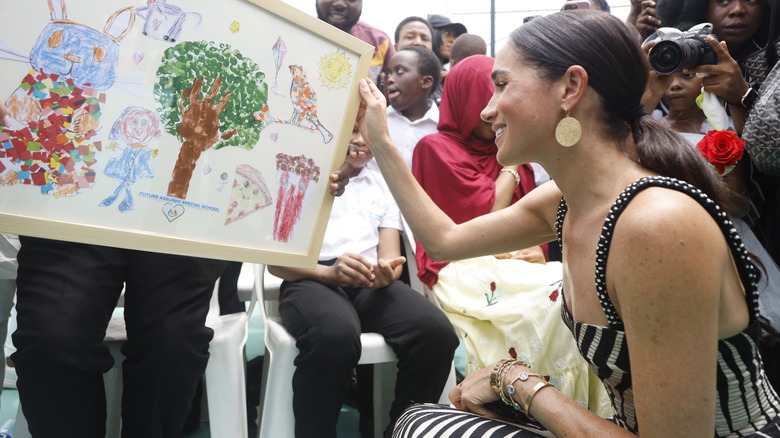 Meghan Markle admiring children's artwork