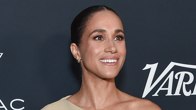 Meghan Markle smiling at a red carpet event