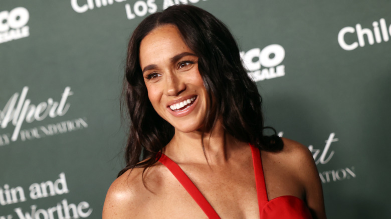 Meghan Markle attends an event in a red dress