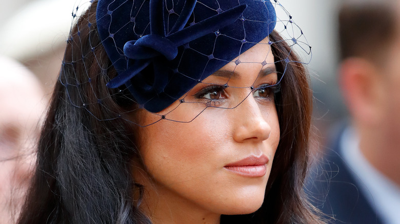 Closeup of Meghan Markle in blue hate and veil