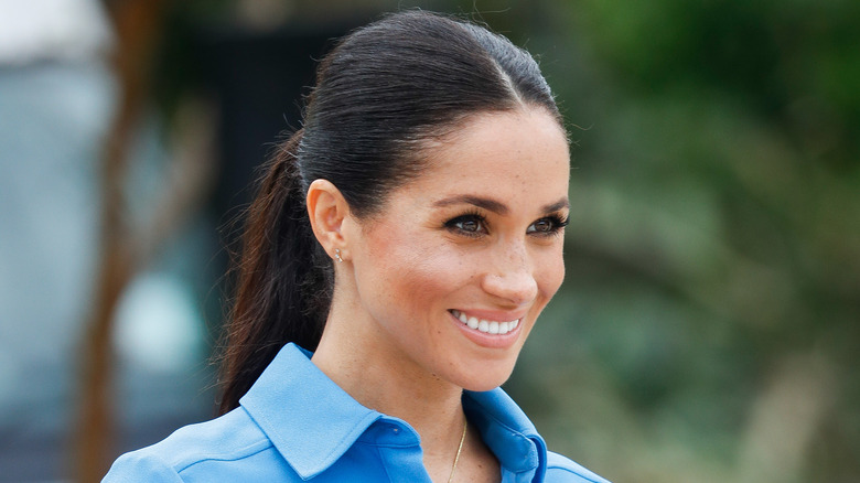 Meghan Markle closeup smiling in blue outfit