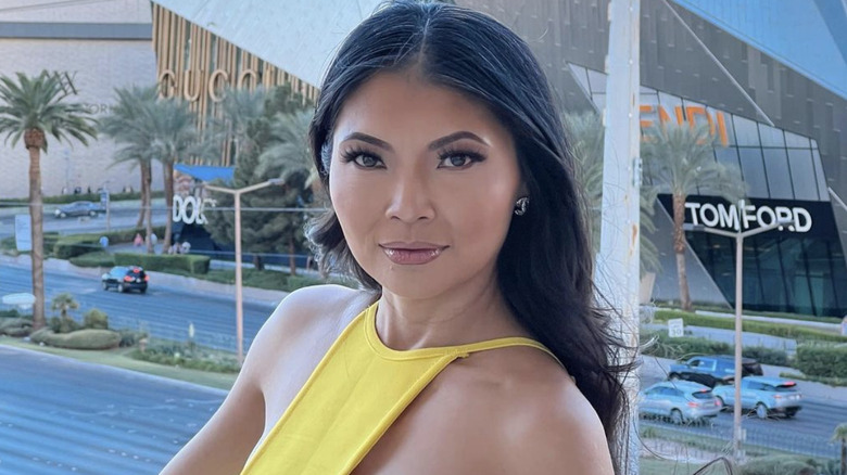 Jennie Nguyen poses on a Las Vegas balcony wearing yellow.