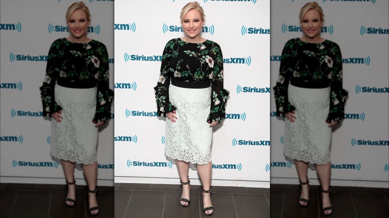 Meghan McCain on red carpet in white lace skirt and black, long-sleeve top