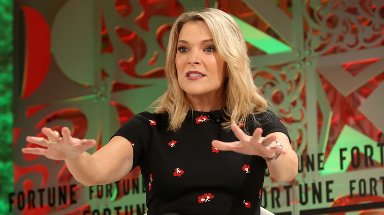 Megyn Kelly reaches her hands out onstage