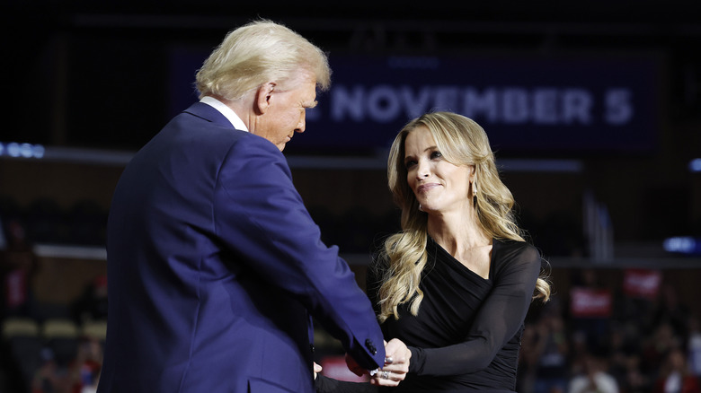 Megyn Kelly shaking Donald Trump's hand on stage at a rally