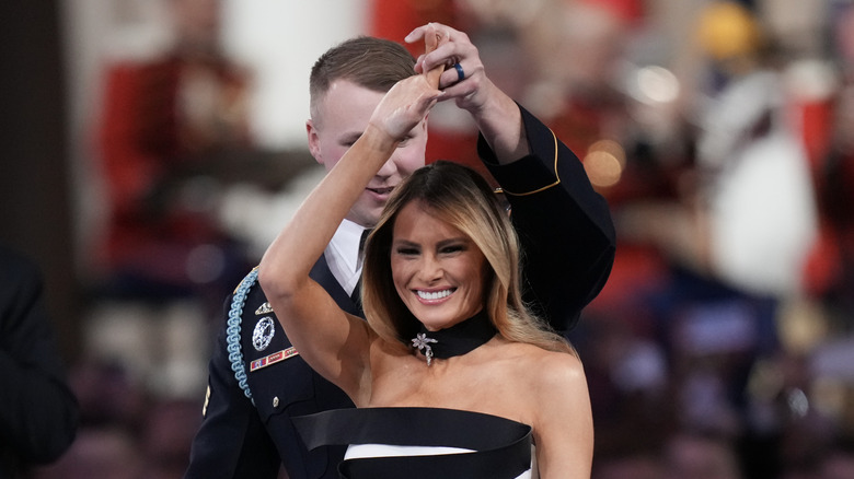 Melania Trump smiling dancing with soldier