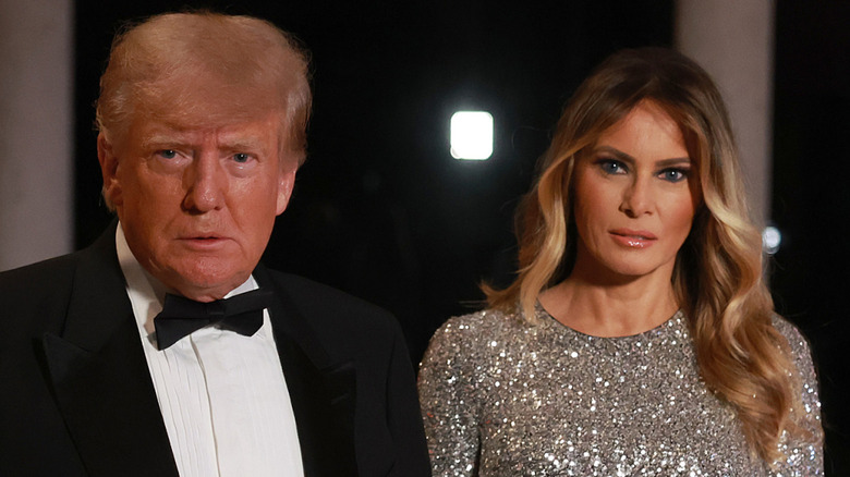 Donald and Melania Trump in formal attires and wide-eyed stares