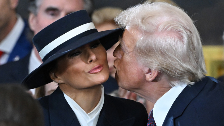 Donald Trump attempts to kiss Melania who is wearing