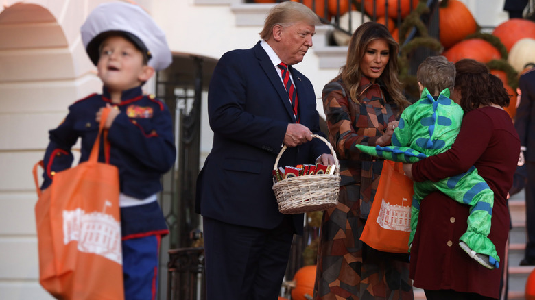 Melania and Donald Trump handing out candy to kids at the White House