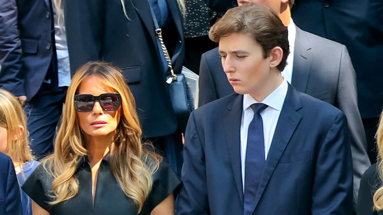  Barron Trump standing next to Melania Trump