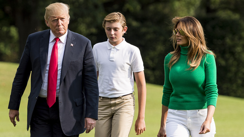 Donald, Barron, and Melania Trump walking