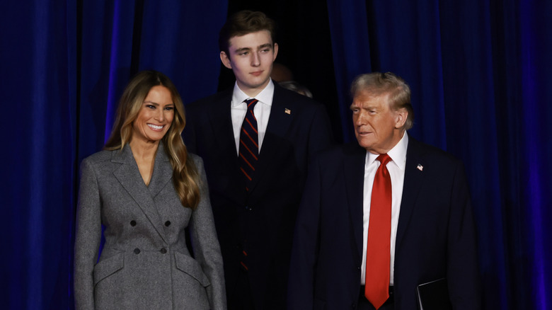 Melania Trump, Barron Trump, and Donald Trump standing together