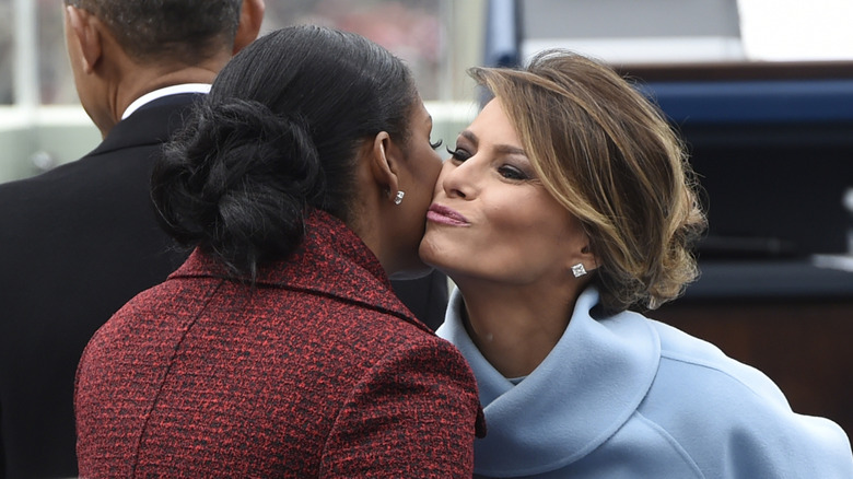 Melania Trump kissing Michelle Obama on the cheek