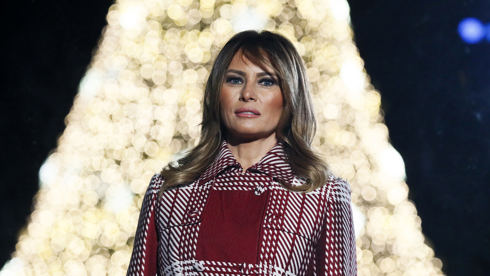 Melania Trump before a Christmas tree