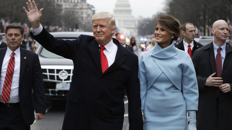 Donald and Melania Trump walk in parade