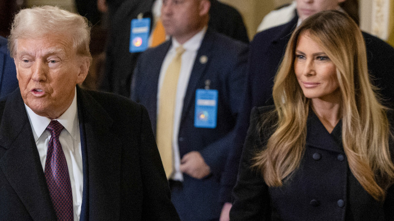 Donald Trump talking while Melania smiles