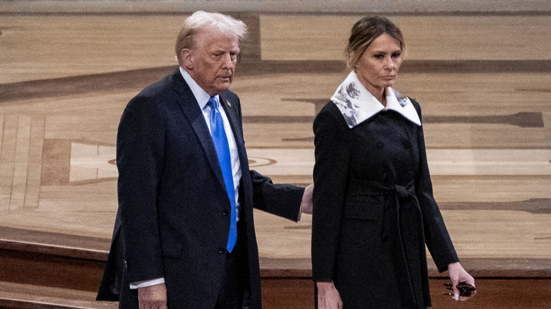 Melania Trump looking solemn with giant collar