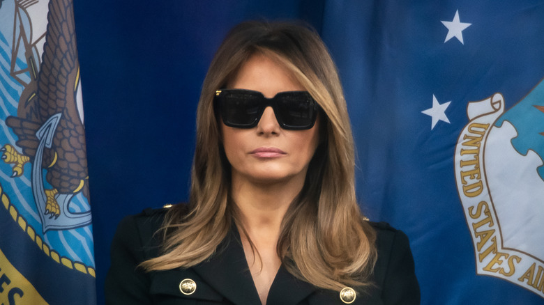 Melania Trump sitting in all-black outfit