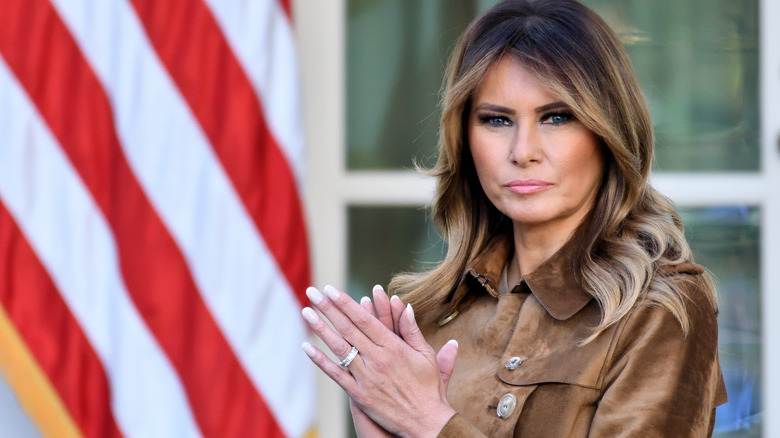 Melania Trump clapping outside the White House at an event