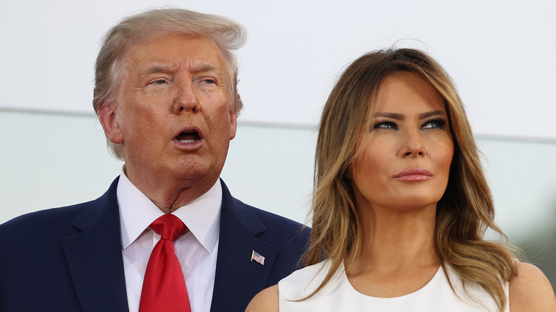 Donald Trump talking and Melania Trump looking annoyed