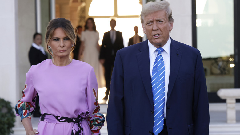 Donald and Melania Trump lilac jumpsuit serious expressions