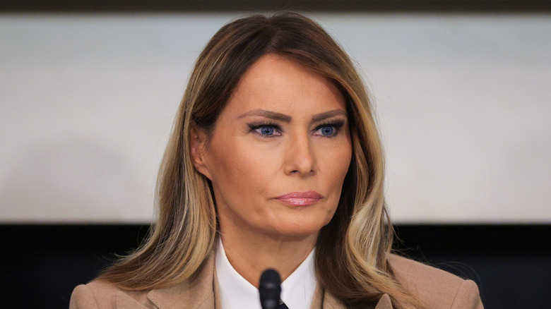 Melania Trump brown suit looking stern