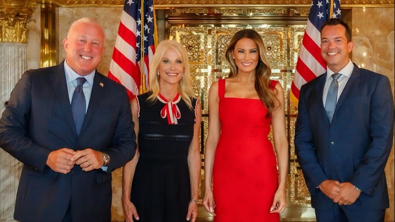 Kellyanne Conway and Melania Trump posing with fundraiser guests