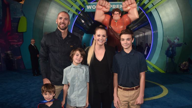 Melissa Joan Hart posing with her sons and husband