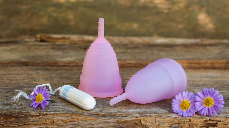 some menstrual cups and a tampon