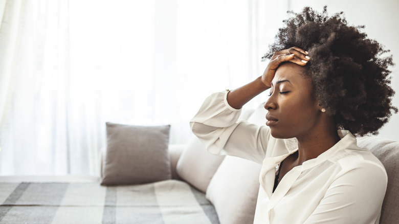 Tired woman sitting on couch