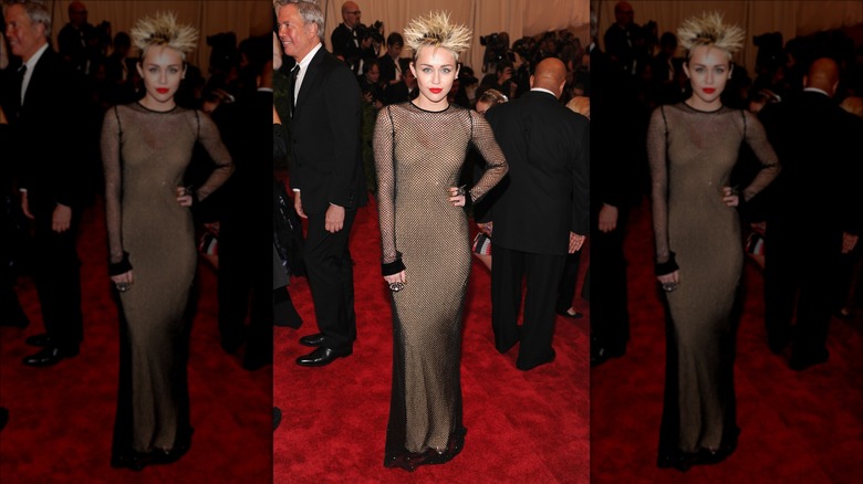 Miley Cyrus in blonde punk hairdo and a sheer gown