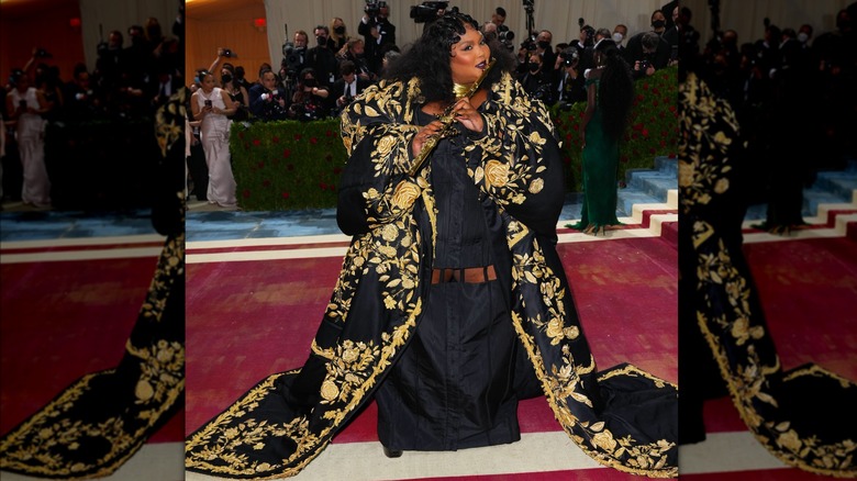 Lizzo in a black and gold gown