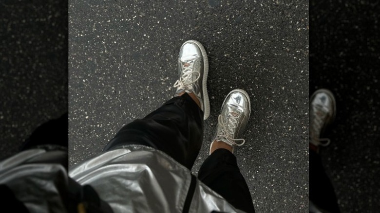 closeup of feet with silver sneakers