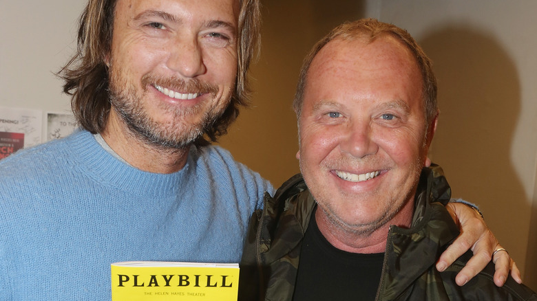 Lance LePere and Michael Kors smile with a Playbill