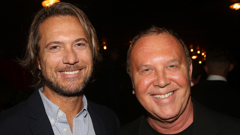 Lance LePere and Michael Kors smile together