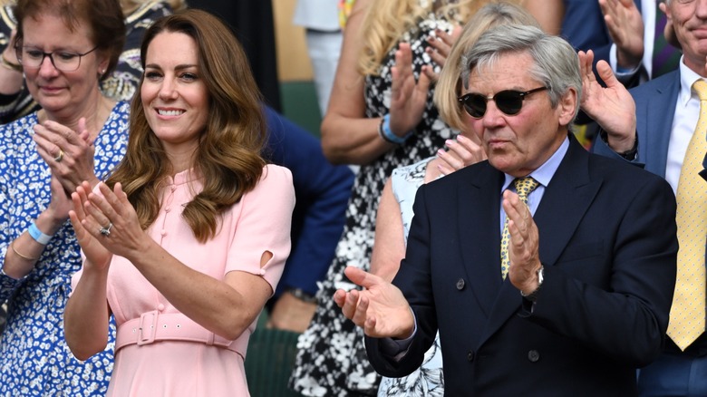 Kate Middleton and Michael Middleton standing, clapping