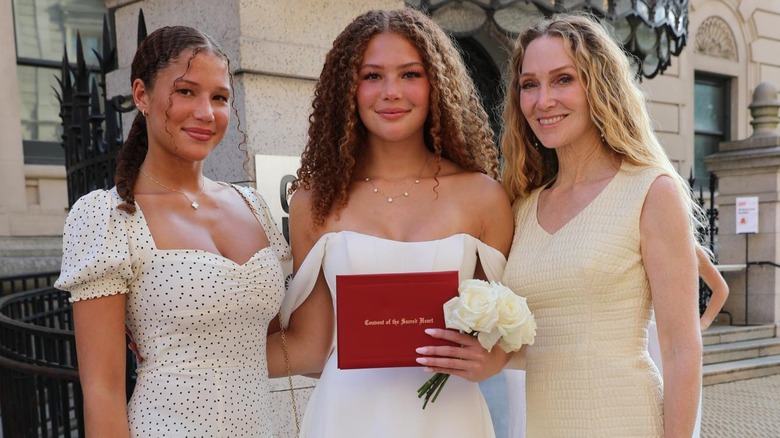 Jean Muggli posing with the twins, Isabella and Sophia, she shares with Strahan