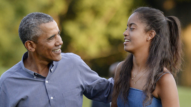 Barak Obama laughing with daughter Malia