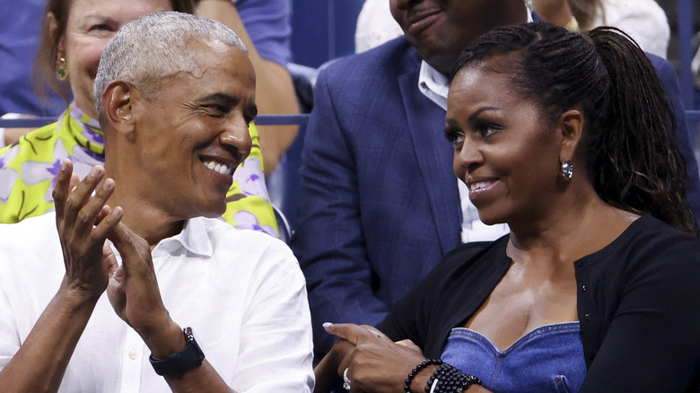 Barack and Michelle Obama smiling at each other