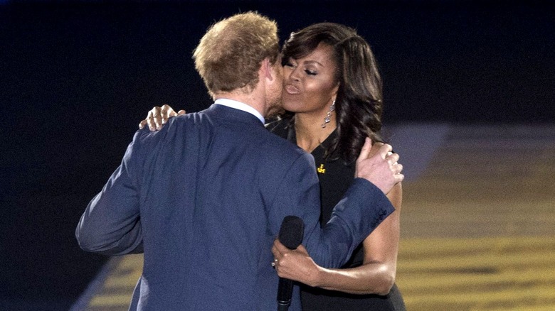 Prince Harry kissing Michelle Obama on stage