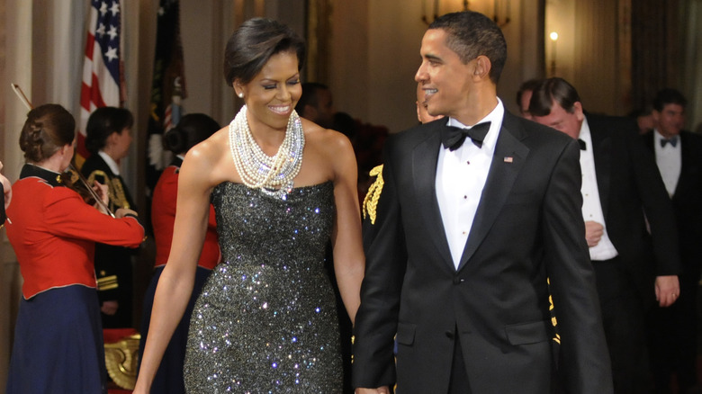 Barack Obama and Michelle Obama smiling at each other