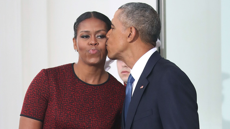 Barack Obama kisses Michelle Obama at the White House