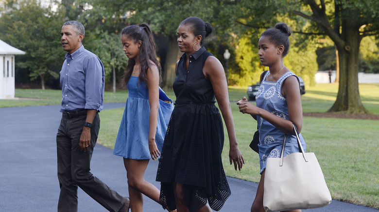 Michelle, Barack, Malia, and Sasha are photographed while walking