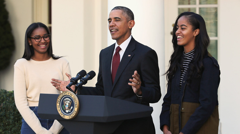 Malia and Sasha Obama with their father