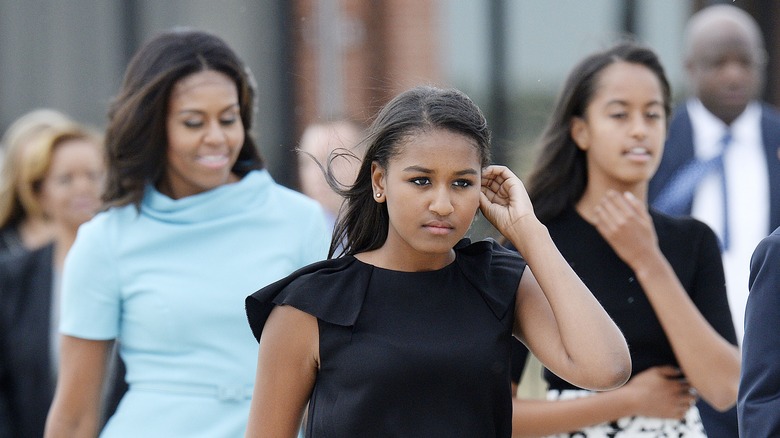 Sasha, Malia, and Michelle Obama walking