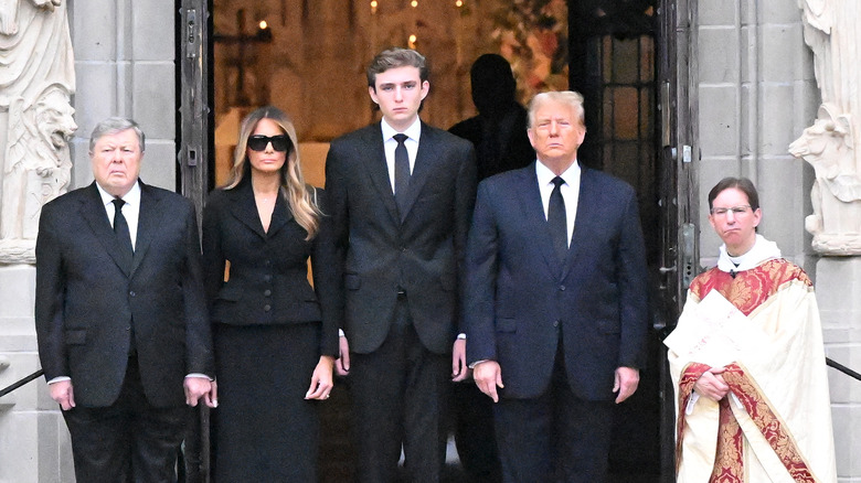 Melania, Barron, and Donald Trump standing with others