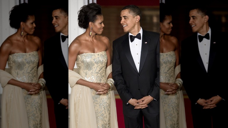 First lady Michelle Obama (L) and President Barack Obama await the arrival of the Indian Prime Minister at the North Portico of the White House in Washington, DC (2009)