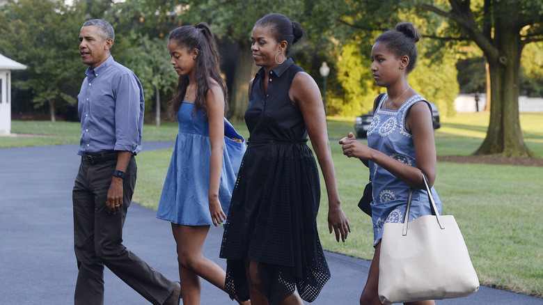 The Obama family walking across a street