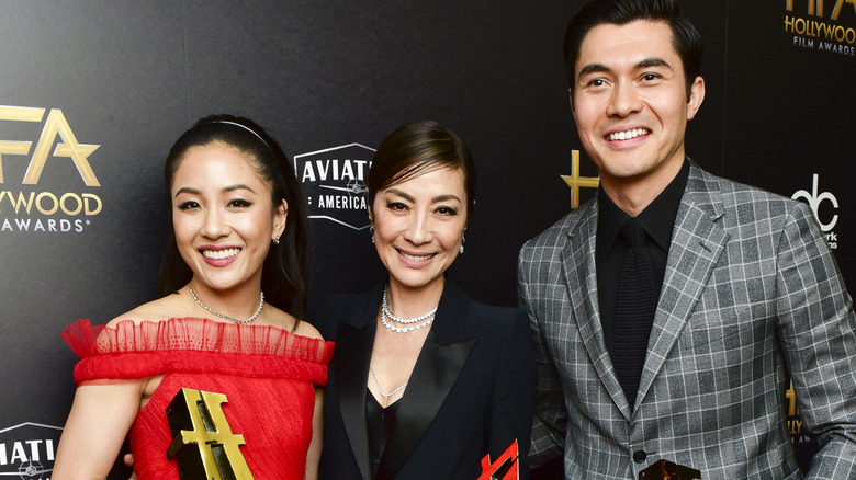 Constance Wu, Michelle Yeoh, and Henry Golding on red carpet 